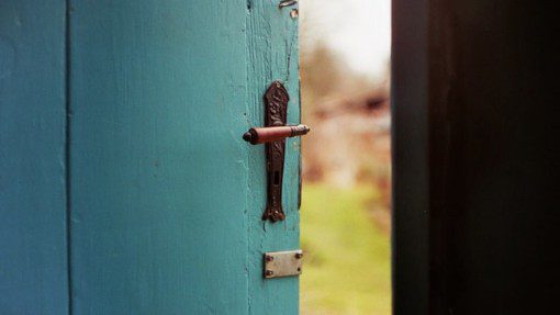 Blue wooden door slightly ajar